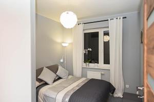 Posteľ alebo postele v izbe v ubytovaní Apartament Wróbelkowo