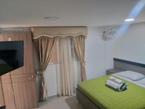 Postel nebo postele na pokoji v ubytování Hotel Ibague Plaza + 37 fotografií