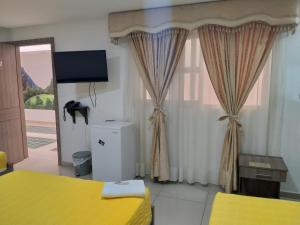 Postel nebo postele na pokoji v ubytování Hotel Ibague Plaza