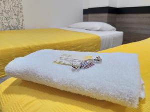 Postel nebo postele na pokoji v ubytování Hotel Ibague Plaza