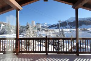 a view of a snowy mountain from a balcony at Hostdomus - Imperial Chalet in Sestriere