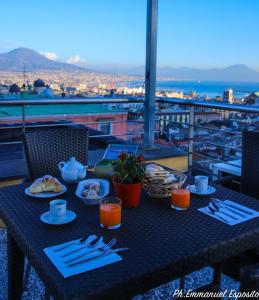 una mesa con platos de comida en el balcón en B&B Nel Regno di Napoli, en Nápoles