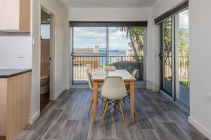 a kitchen and dining room with a table and chairs at Bay 10 - Suites and Apartments in Port Lincoln