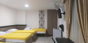 Postel nebo postele na pokoji v ubytování Hotel Ibague Plaza