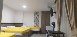 Postel nebo postele na pokoji v ubytování Hotel Ibague Plaza