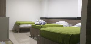 Postel nebo postele na pokoji v ubytování Hotel Ibague Plaza