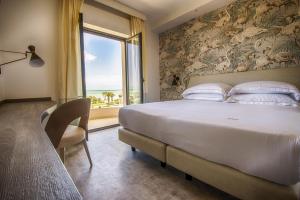 a bedroom with a large bed and a window at Ghibli Hotel in Civitanova Marche