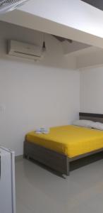 Postel nebo postele na pokoji v ubytování Hotel Ibague Plaza