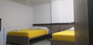 Postel nebo postele na pokoji v ubytování Hotel Ibague Plaza