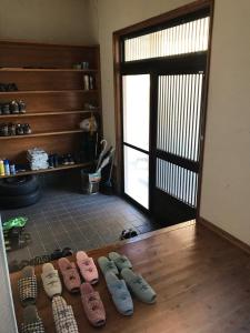 
a room with a wooden floor and wooden flooring at Minshuku Nodoka in Yakushima
