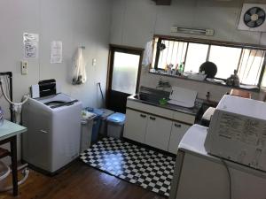 
a room with a desk and a computer on it at Minshuku Nodoka in Yakushima
