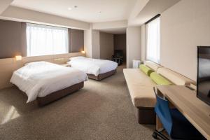 Postel nebo postele na pokoji v ubytování JR Clement Inn Takamatsu