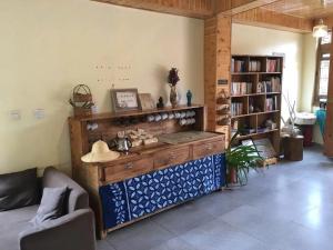 a living room with a large wooden cabinet in a room at Tourist Courtyard Hotel in Jianchuan
