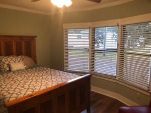 a bedroom with a bed and two windows with blinds at Beaufort SC New Renovation, Close to Parris Island, Historic Downtown, Beautiful Beaches, Sleeps 6 in Beaufort