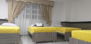 Postel nebo postele na pokoji v ubytování Hotel Ibague Plaza