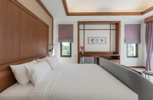 a large white bed in a room with windows at Villa Palavee (A2) in Ao Nang Beach +31 photos