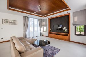 a living room with a couch and a flat screen tv at Villa Palavee (A2) in Ao Nang Beach