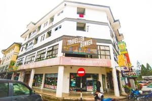 a large white building on a city street at Traveller Bunker Hostel in Cameron Highlands