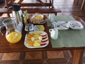 a wooden table with a tray of food on it at Epic Adventure Lodge in San Miguel