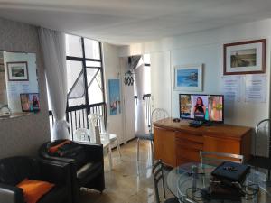 una sala de estar con TV en un tocador de madera en Flat Mar Brasil Tropical - Apartamento de 2 Quartos com Suite e Vista do Mar, en Fortaleza