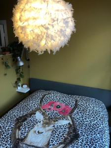 
a piece of cake on a bed with a lamp at Juuls B&B in Delft
