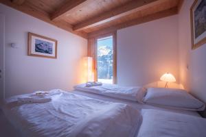Postel nebo postele na pokoji v ubytování Chalet Roossi 3