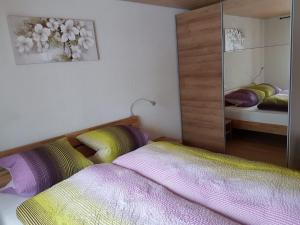a bedroom with two beds and a mirror at Chalet Grüneggli in Adelboden