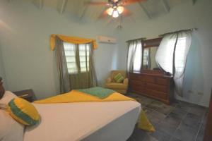 a bedroom with a bed and a dresser at Lamblion Holiday Apartment in Freemans