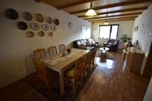 a dining room and living room with a table and chairs at Privat BEA in Podtureň