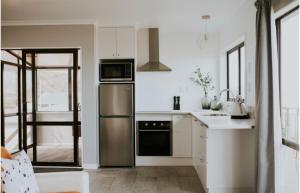 a kitchen with a stainless steel refrigerator and a sink at Apartment 278 in Eskdale