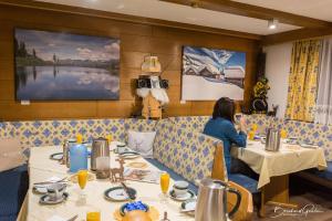 a woman sitting at a table in a restaurant at Haus am Lift in Kappl