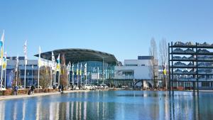 a large pool of water in front of a building at Aparthotel my room - Messe Munich in Munich