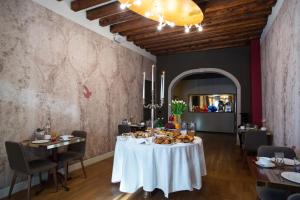 a dining room with a table with food on it at Riva del Vin BOUTIQUE HOTEL in Venice