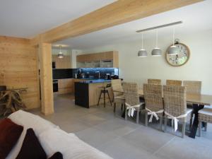 a kitchen and dining room with a table and chairs at Chalet. Les Fermes de Vars in Vars