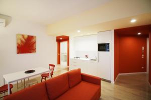 a living room with a couch and a table and a kitchen at Myresidenceverona in Verona