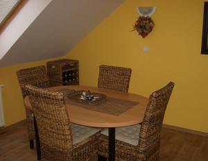 a dining room table and chairs with a fireplace at Apartment Mikulov, Husova Ulice in Mikulov