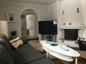 a living room with a couch and a coffee table at Lilla Huset Oleby in Torsby