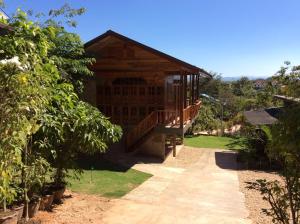 a wooden house with a porch and a balcony at Settee Homestay in Nan