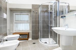 a bathroom with a shower and a toilet and a sink at My Lodge Italy Centro Storico in Naples +16 photos