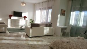 a white living room with a couch and a table at XX Settembre Matera - Apartment in Matera