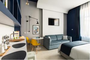 a bedroom with a bed and a couch and a table at My Lodge Italy Centro Storico in Naples