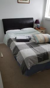 a bed with two pillows on it in a bedroom at Fully Equipped Modern 3 bedroom House in Bishops Stortford
