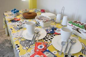 a table with plates and spoons on top of it at B&B A casa di Emy in Barisciano +23 photos
