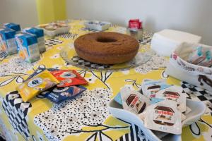 a table with a cake and some snacks on it at B&B A casa di Emy in Barisciano