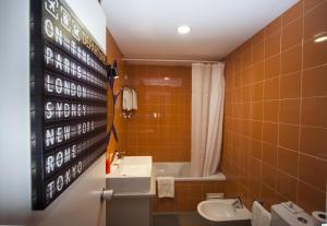 a bathroom with a sink and a toilet and a shower at Hotel Made Inn in Portimão +45 photos