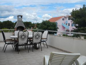 a patio with a table and chairs on a balcony at Apartments Ankica in Šibenik