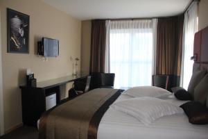 Postel nebo postele na pokoji v ubytování Hotel La Roseraie