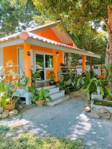 an orange house with plants in front of it at Baan Chid Talay in Ko Chang