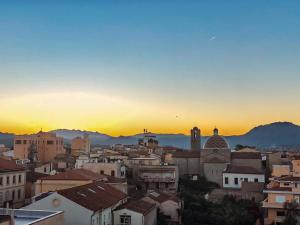 a city skyline with a sunset in the background at Marysel Rooms in Olbia