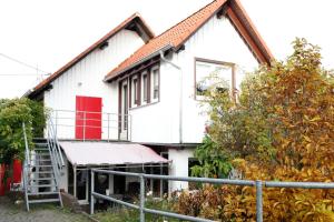 a house being built with a red door at Hestavin Bed & Breakfast in Grünberg +9 photos